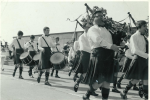 A procession in the sixties, with Bill Hennessy, John Mahon(?) and Mike Higgins on the side drum, Tony Sherratt on the tenor drum, and Terry Dowling, Peter Cummins and Bill Lisgo on the pipes.